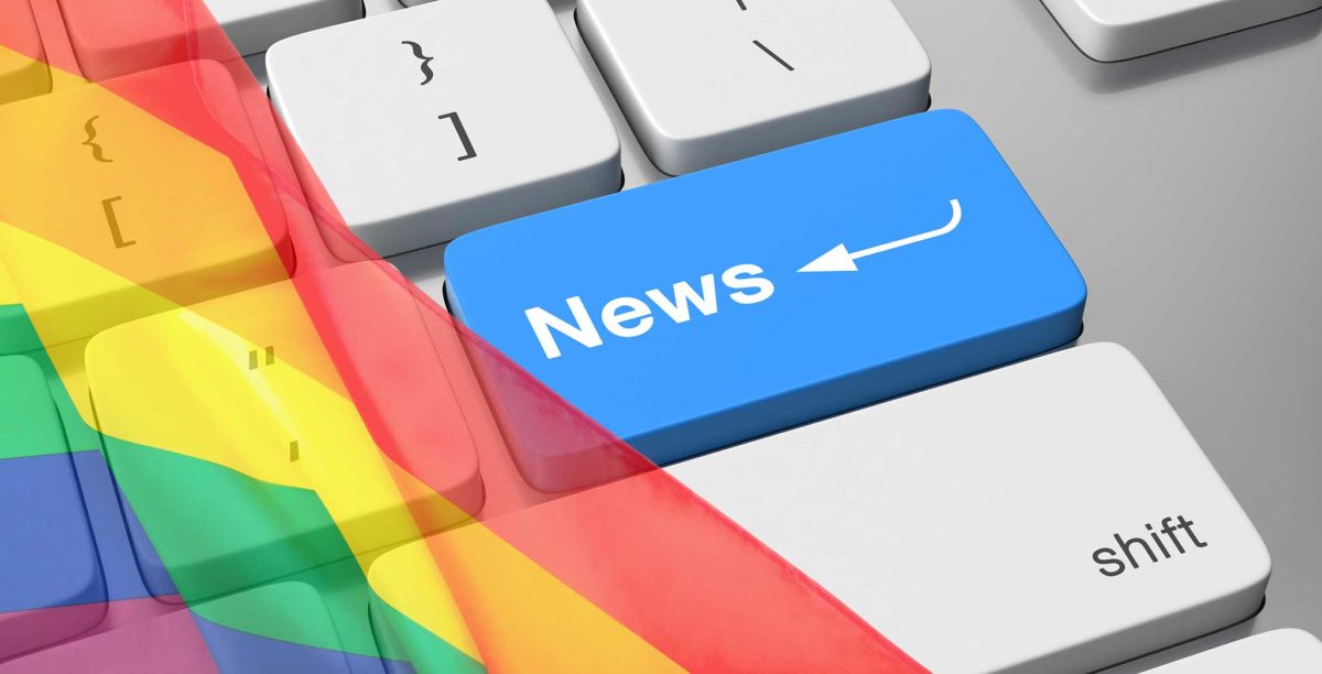 Computer keyboard with NEWS printed on the enter key, surrounded by a PRIDE rainbow flag